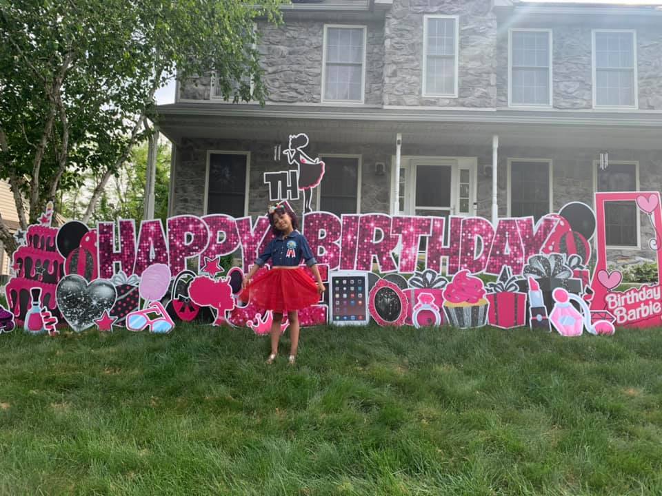 a little girl in front of a happy birthday yard sign in waldorf, md
